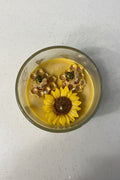 Vela aromatica de girasol con detalles de abeja y panal, hecha a mano, presentada en empaque elegante para regalo.